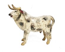 South American cast metal model of a bull, with polychrome slip glazed decoration, 43cm long (
