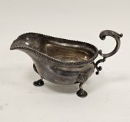 George V silver sauceboat with ribbed border, raised on three scallopshell feet, Birmingham 1929,