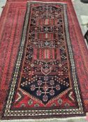 Iranian rug, very tribal to region, unusual pattern to centre with green, red, cream and brown
