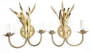 In the manner of Hans Kogl, pair of gilt metal double-branch wall lights in the form of