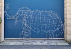 Galvanised metal sculpture of a full sized elephant with its trunk raised, 355cm long x 100cm wide x