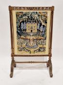 Early 20th century firescreen with a foliate carved giltwood frame and woolwork panel of a country