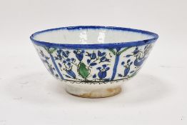 A Persian (Kashan) pottery bowl, 18th-19th century, painted with birds and foliage within panels,