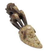 African tribal wooden face mask with integrated carved head piece, possibly Igbo, the long elongated