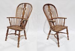 Two 19th century ash and elm seated hoop back Windsor elbow chairs with pierced carved splats,
