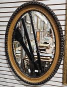 Early 20th century oval bevelled edge mirror, the wooden frame with moulded and beaded edge, 87cm