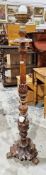 Early 20th century wooden standard lamp, the column ornately carved with acanthus leaves, raised