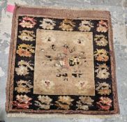 Unusual old Iranian rug, the centre square panel brown, gold, red on brown with border of green,