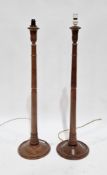 Pair of short mahogany standard lamps, the turned inverted tapering columns carved with acanthus