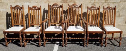 Six early 20th century oak dining room chairs including two carvers with domed carved top rail,