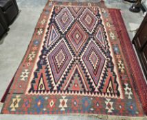 Flat weave kilim, diamond designs to centre in light blue, dark blue, green, reds, creams, black,
