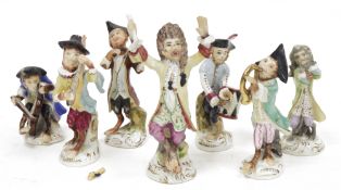 Continental porcelain seven piece monkey band, circa 1900, comprising: a conductor and six monkey
