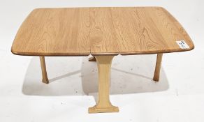 Ercol pale elm and beech drop-leaf Sutherland coffee table, raised on shaped supports with gatelegs,
