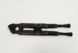 Asian or ethnic two knife dagger set, each with carved ebony handle and contained in a carved wooden