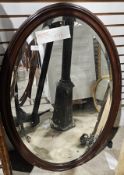 Early 20th century oval mahogany framed mirror, the plate with bevelled edge, 86cm long