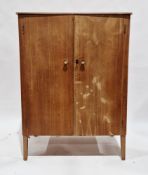 Mid century walnut compact wardrobe by Gordon Russell, the two panel doors opening to a hanging