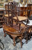 Early 20th century mahogany dining room suite comprising an oval wind-out dining table with