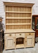 18th/19th century pine dresser with rack, the upper section with moulded cornice, panel back and