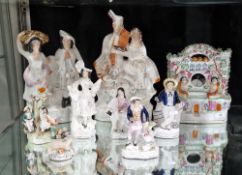 Collection of late 19th century Staffordshire pottery figures and groups, including: a putti spill