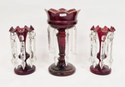 Three Victorian ruby glass lustres, comprising: a pair of ruby lustres with clear cut pendant drops,