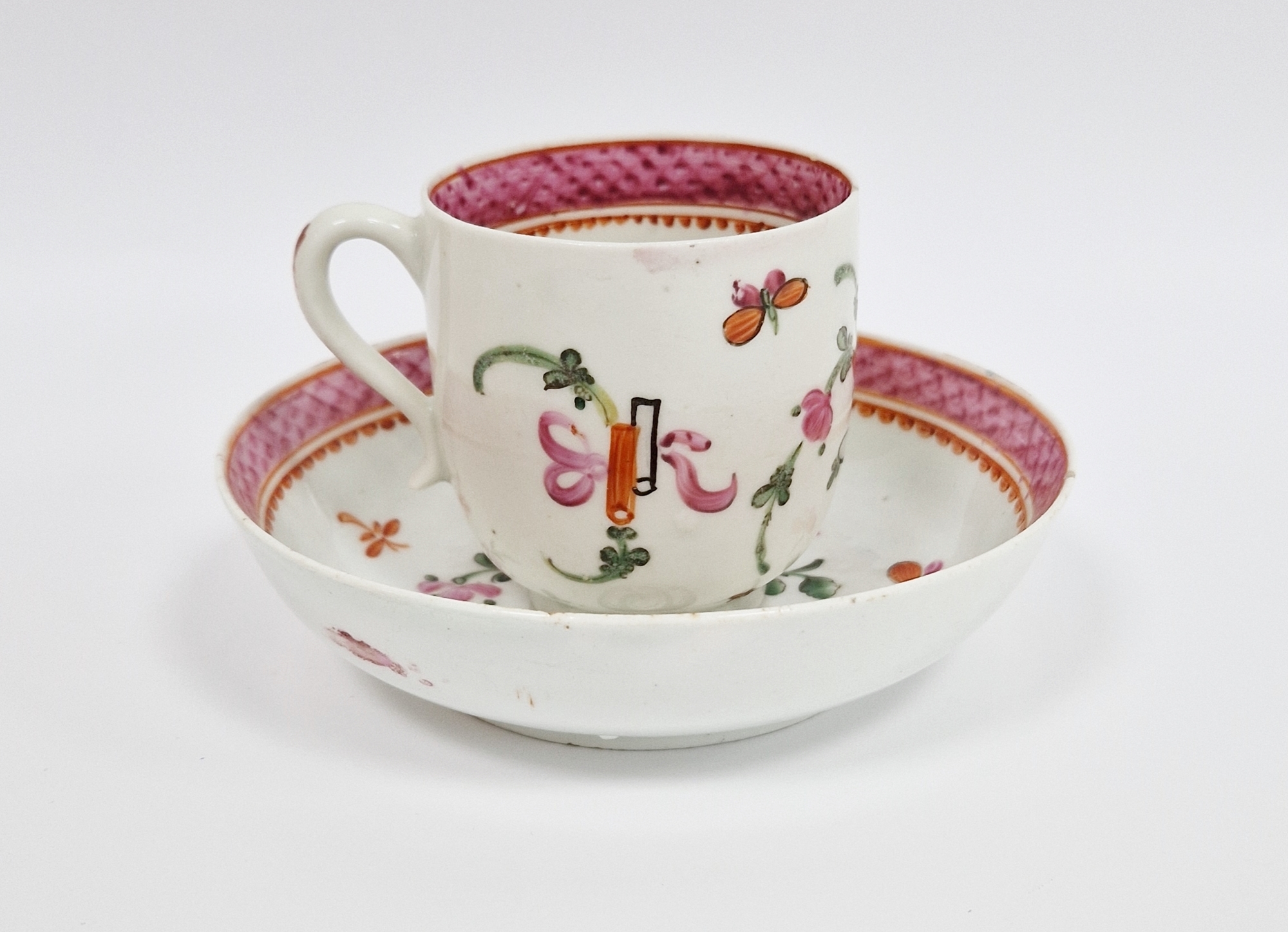 Lowestoft porcelain famille rose 'Top Hat' pattern coffee cup and saucer, circa 1765-75, painted
