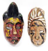 Two ethnic wooden carved face masks, with polychrome decoration, 24.5cm high Condition Report For