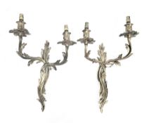 Pair of gilt brass twin branch wall lights in the rococo manner with foliate scroll casting, each
