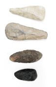 Four antique stone axe heads, probably Neolithic, one with hand written inscription ' Rochester 1874