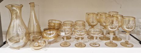 Continental enamelled monogrammed gold lustred glass part table service, circa 1900, decorated in