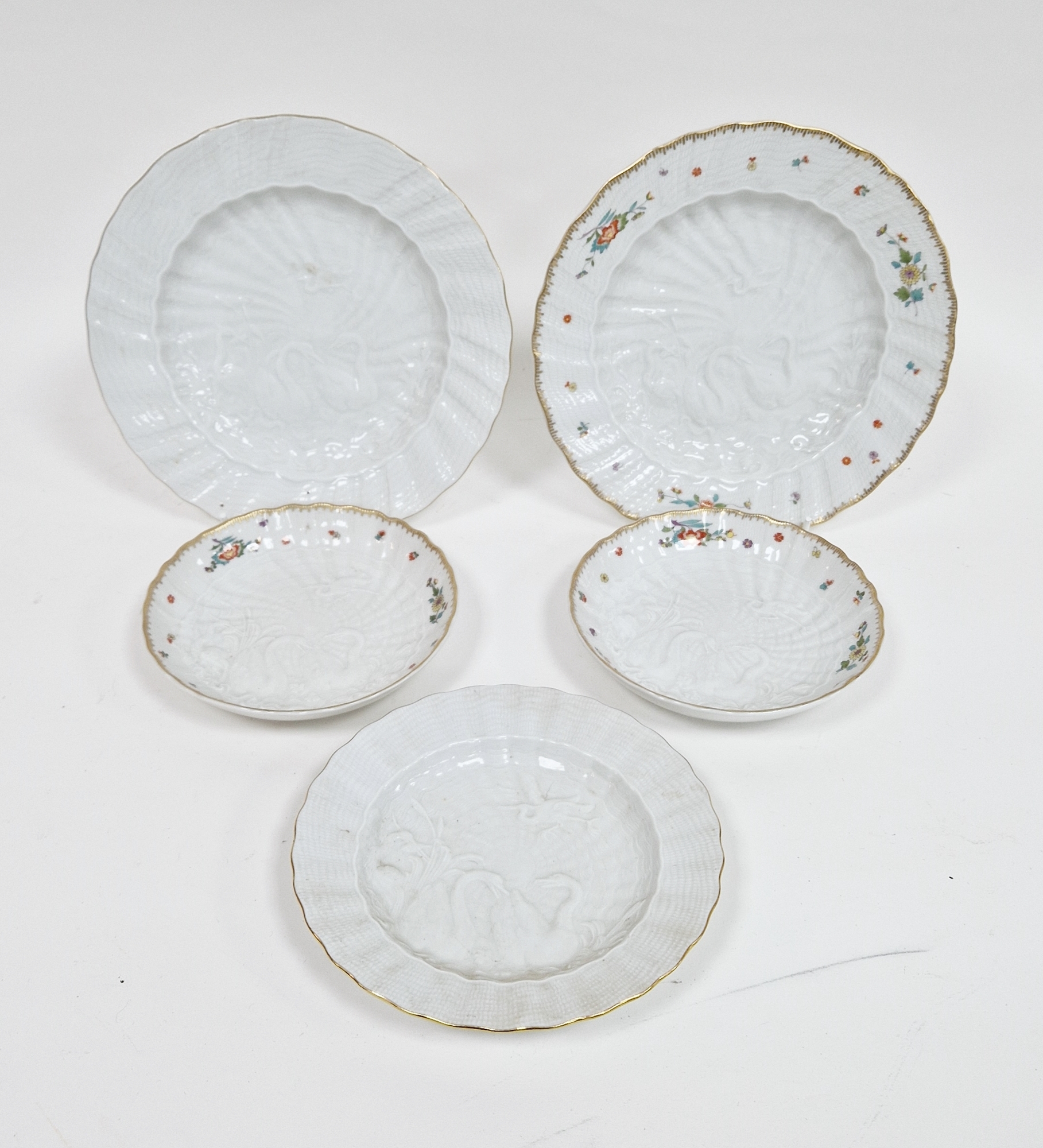 A group of 19th and early 20th century Meissen Swan Service plates and saucers, blue crossed swords,