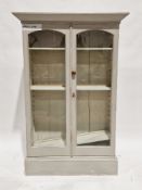 Late 19th/early 20th century glazed display cabinet later painted green, the two glazed arched doors