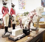 Two resin models of foxes in hunting dress, one holding a French hunting horn, the other a riding