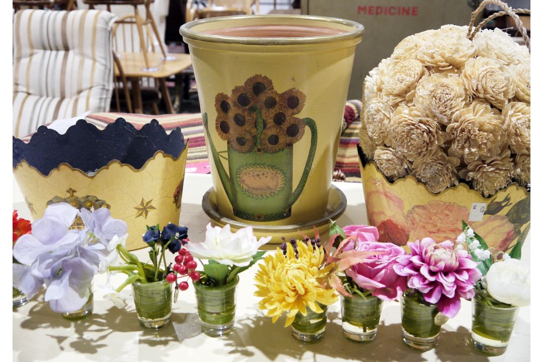 Various decoupage flower planters, various posies of faux-flowers made by Bloom and a decorative