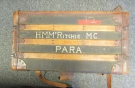 Early 20th century wooden bound canvas travelling truck with leather straps, marked to top 'H.M.