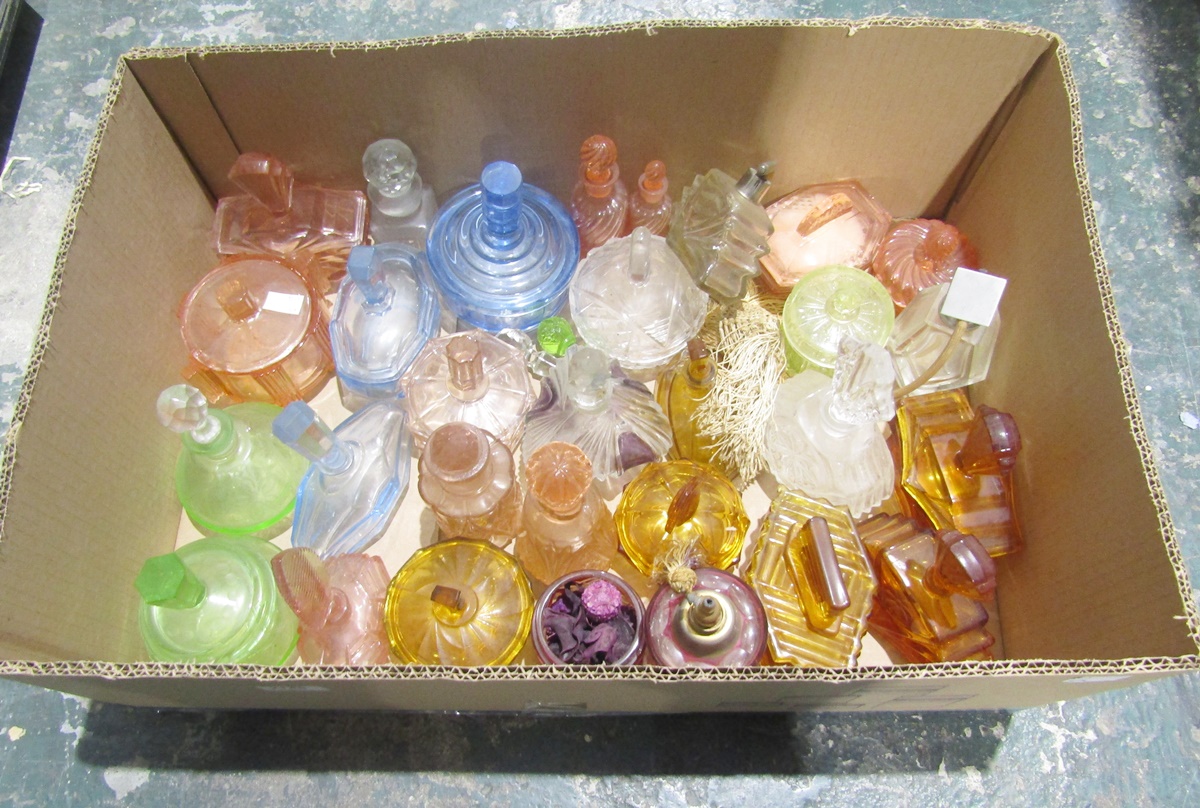 Collection of approx. 30 early 20th century clear and coloured moulded glass perfume bottles,