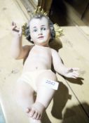 Ceramic figure of a baby, possibly a Baby Jesus from a crib set