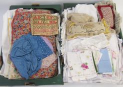 A quantity of assorted embroidered and printed table linen and textiles, two lace making pillows,