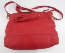 A Mulberry red leather tote bag, plaited handles and a shoulder strap, with original dust bag,