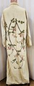A 1920's linen duster coat/dressing gown embroidered on the back in wool a briar rose, with a padded