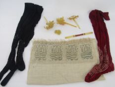 Two pairs of 1920's embroidered silk stockings, one black and the other dark red, a cream silk