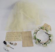 A net wedding veil with a note saying 'My wedding veil November 20th 1851', a wedding headdress with