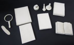 Collection of bisque fired white stoneware desk top objects consisting of five books, an inkwell and