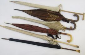 Six vintage silk parasols, including a black silk parasol with gilt-metal mounted malacca cane