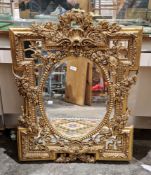20th century gilt framed wall mirror in the George III manner, elaborately moulded with shells,