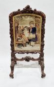 Victorian mahogany firescreen, the surround with heavy foliate scroll carving and floral crest and