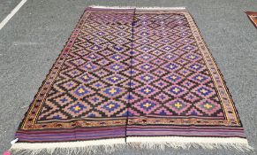 Uzbek two-part kilim with piled border on brown, indigo, purple background with diamond lozenges,