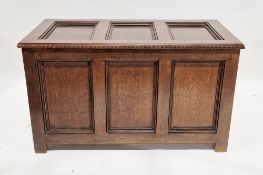 20th century oak three-panel coffer with carved edge and raised on stile feet, 62cm high x 106cm