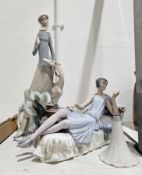 A tall Lladro figure of a lady beside a deer, on tree stump base and a Lladro figure of an Art