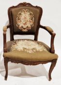 Walnut elbow chair in the French Louis XV manner, with floral carved top rail and needlework