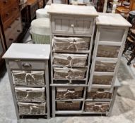 Four grey painted storage cabinets, each with shelving holding wicker fabric lined baskets,